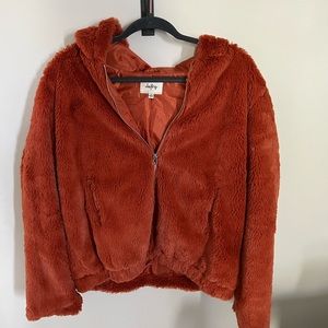 Burnt orange color, fuzzy, soft lined jacket, never worn